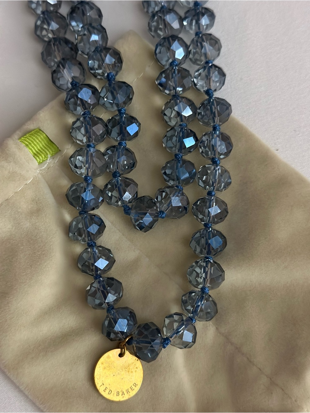 Ted Baker Blue Faceted Bead Necklace with Gold Disc Pendant.